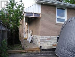 Toronto (Dorset Park) apartment for rent - A house with a ladder and a tree in front of it.