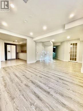 Richmond Hill (Doncrest) apartment for rent - A spacious room with wooden flooring and white walls.