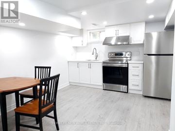 Clarington (Bowmanville) apartment for rent - A kitchen with a wooden table and chairs.