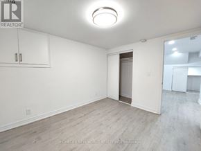 Clarington (Bowmanville) apartment for rent - A room with a white wall and a wooden floor.