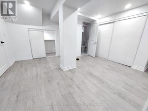 Clarington (Bowmanville) apartment for rent - A spacious room with white walls and a grey floor.