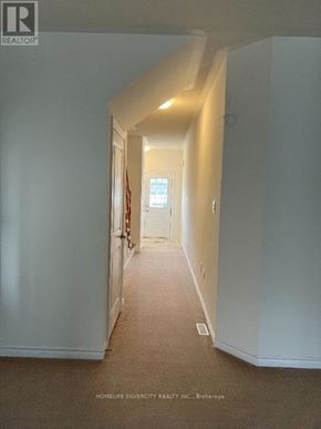 Southgate apartment for rent - A hallway with white walls and carpeted floor.