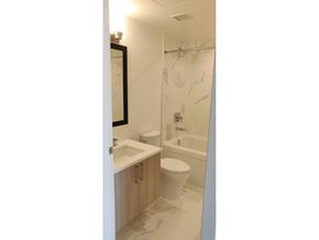Surrey apartment for rent - A bathroom with a toilet, sink, and shower.