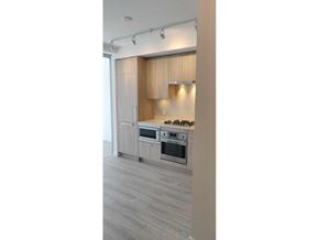 Surrey apartment for rent - A kitchen with a stove top oven and a microwave.