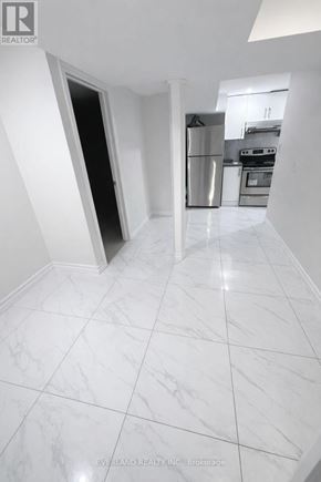 Toronto (Agincourt South-Malvern West) apartment for rent - A kitchen with white marble flooring and a stainless steel refrigerator.