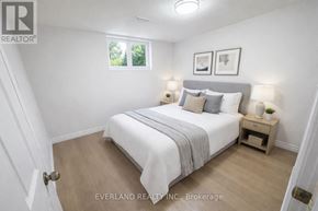 Toronto (Agincourt South-Malvern West) apartment for rent - A bedroom with a bed, nightstands, and a window.