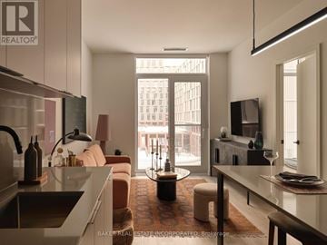 Toronto (Waterfront Communities) condo for rent - A modern kitchen with a dining area and a living room with a couch and a chair.