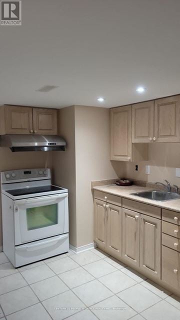 Mississauga (Central Erin Mills) apartment for rent - A white stove and oven in a kitchen with beige cabinets.