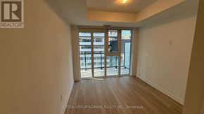 Toronto (Church-Yonge Corridor) condo for rent - A room with a view of a cityscape through a glass door.