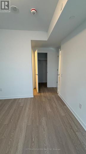 Toronto (Church-Yonge Corridor) condo for rent - A hallway with a wooden floor and white walls.