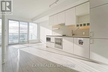Vaughan (Vaughan Corporate Centre) condo for rent - A modern kitchen with white cabinets and a tiled backsplash.