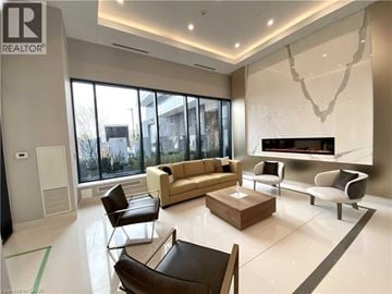 Mississauga condo for rent - A living room with a brown leather chair and a white couch.