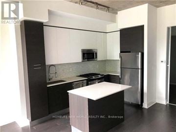 Toronto (Waterfront Communities) condo for rent - A modern kitchen with black and white appliances and cabinets.