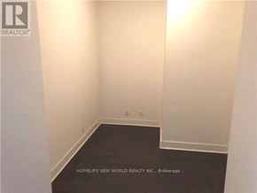 Toronto (Waterfront Communities) condo for rent - A room with a black floor and white walls, with the text "HOMELIFE NEW WORLD REALTY INC. Brokerage" on the bottom.