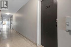 Hamilton condo for rent - A hallway with a black door labeled 304.