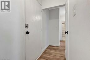 Hamilton condo for rent - A hallway with a door on the left and a door on the right.