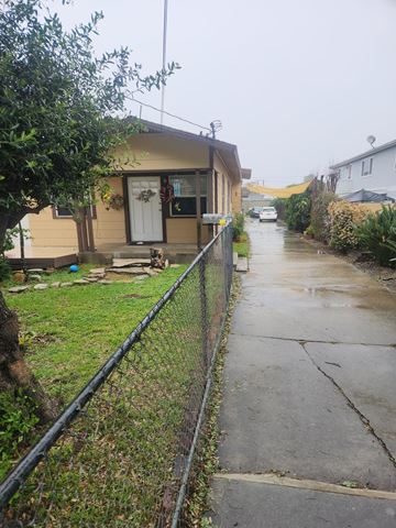 Lomita apartment for rent - A house with a white door and a fence on the side.
