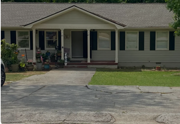 Lawrenceville apartment for rent - A house with a grey roof and a white porch.