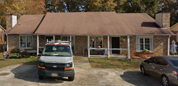 Lawrenceville apartment for rent - A house with a van and a car parked in front.