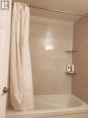 Markham (Victoria Square) apartment for rent - A white shower curtain hangs over a white bathtub in a bathroom.