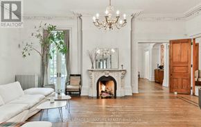 Toronto (Cabbagetown-South St. James Town) apartment for rent - A white living room with a fireplace and a chandelier.