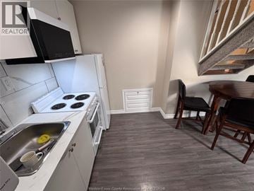 Windsor apartment for rent - A kitchen with a stove top oven and a sink.