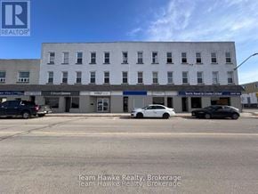 Midland multi-family for rent - A building with the sign Team Hawke Realty Brokerage in front of it.