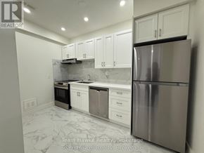 Midland multi-family for rent - A kitchen with white cabinets and a marble floor.