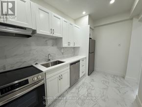 Midland multi-family for rent - A kitchen with white cabinets and marble countertops.