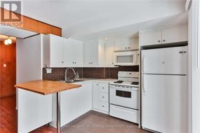 Toronto (Newtonbrook West) apartment for rent - A kitchen with white appliances and cabinets.
