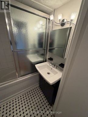 Toronto (Junction Area) multi-family for rent - A bathroom with a sink, mirror, and shower.