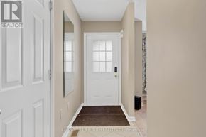 Barrie (Georgian Drive) apartment for rent - A hallway with a white door and a brown rug on the floor.