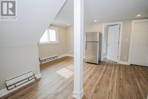 Port Colborne (East Village) multi-family for rent - A room with a refrigerator and a window.