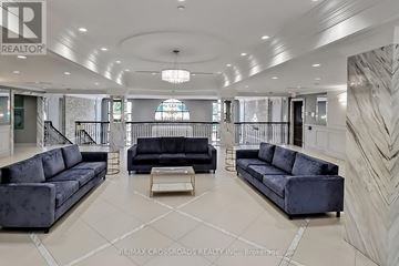 Markham (Unionville) townhouse for rent - A spacious living room with a black sofa and a coffee table.
