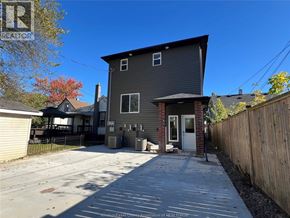 Windsor apartment for rent - A house with a grey exterior and a white door is shown.