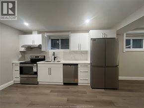 Windsor apartment for rent - A kitchen with a refrigerator, sink, and stove.