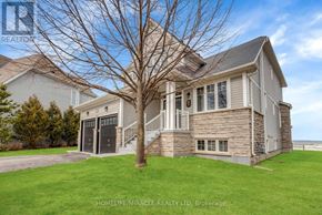 Wasaga Beach apartment for rent - A living room with a large window overlooking the beach.