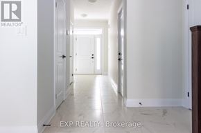 Kitchener apartment for rent - A long hallway with white walls and marble floors.