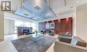 Toronto (Woburn) condo for rent - A modern living room with a glass coffee table and a fireplace.