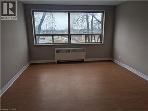 Hamilton condo for rent - A room with a window and a radiator on the floor.