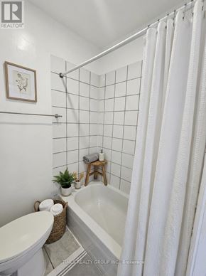 Toronto (Bedford Park-Nortown) multi-family for rent - A white bathroom with a tub, toilet, and sink.