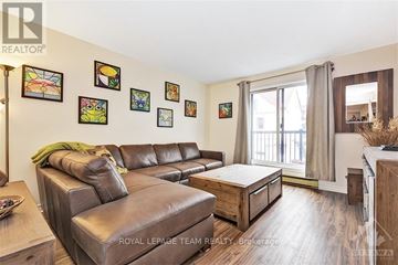 Ottawa townhouse for rent - A living room with a brown leather couch and a coffee table.