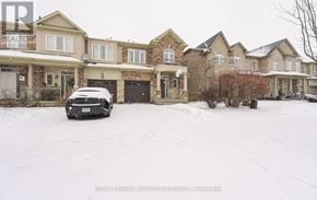 Hamilton (Stoney Creek Mountain) townhouse for rent - A black car is parked in front of a house with a snowy front yard.