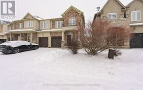 Hamilton (Stoney Creek Mountain) townhouse for rent - A black car is parked in front of a house with a snowy landscape.