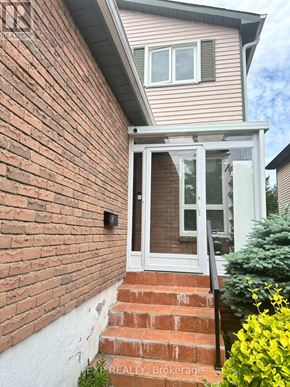 Toronto (Milliken) apartment for rent - A house with a brick wall and a glass door.