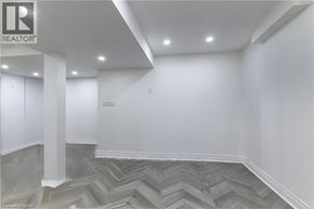 Hamilton apartment for rent - A room with a grey chevron patterned floor and white walls.