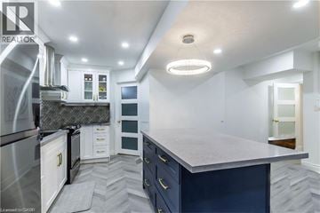 Hamilton apartment for rent - A modern kitchen with a large island and stainless steel appliances.