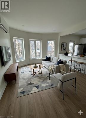 Hamilton apartment for rent - A living room with a grey sofa and a rug with a geometric pattern.
