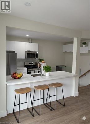Hamilton apartment for rent - A kitchen with white countertops and wooden stools.