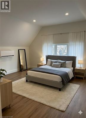Hamilton apartment for rent - A bedroom with a large bed and a window with curtains.